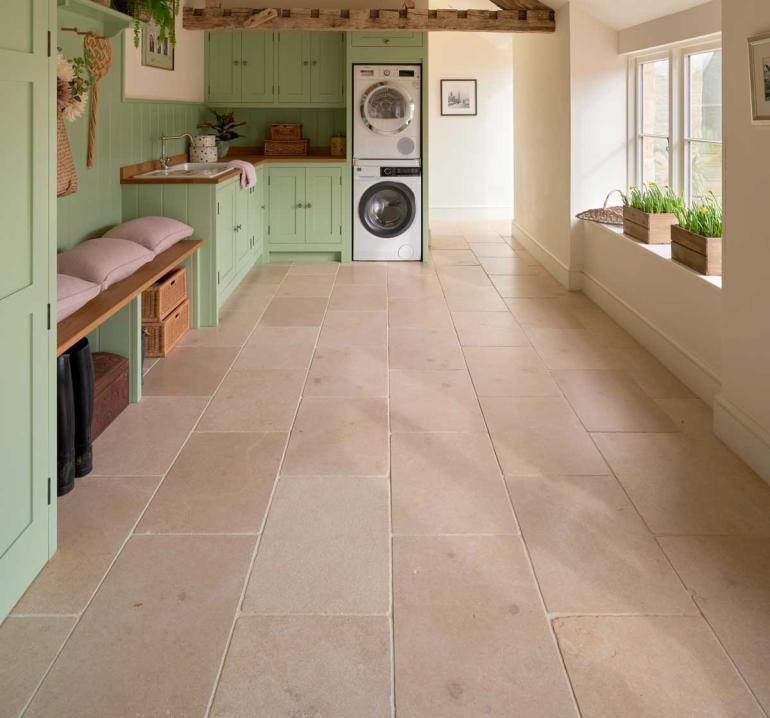Buscot Limestone Tumbled tiles also feature in the utility room