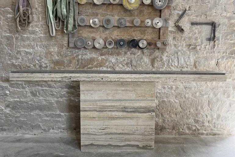 A completed travertine console table in the couple's studio – this was created for a private client