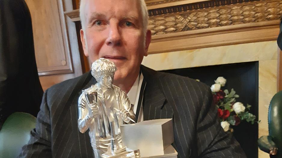 Master Martin Low with the statuette he donated