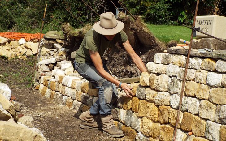 Emma Knowles building a dry stone wall