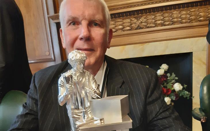 Master Martin Low with the statuette he donated