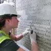 Cleaning letters on a memorial