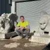 Ryan outside his workshop at Traditional Stone with the two completed griffins