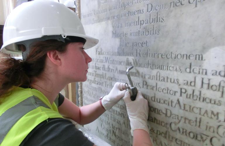 Cleaning letters on a memorial