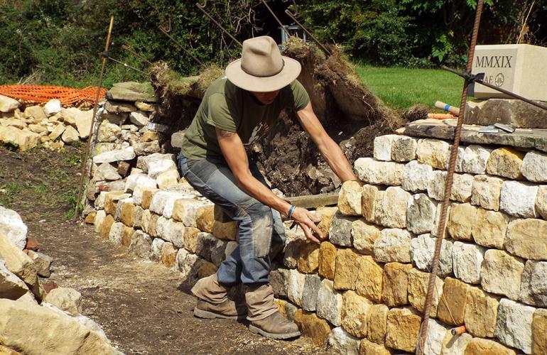 Emma Knowles building a dry stone wall